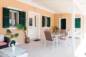 a living room with a table and chairs at Matoula's House in Nydri