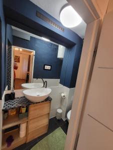 a bathroom with a white sink and a blue wall at MINT APARTMENTS in Zadar