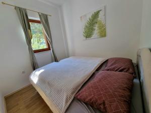 a bedroom with a bed in a room with a window at Holiday Home Harmony in Mostar +14 photos