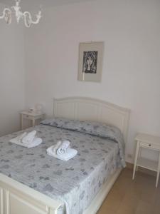 a bedroom with a bed with two slippers on it at Central Station House in Santa Marinella