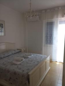 a bedroom with a bed with two towels on it at Central Station House in Santa Marinella