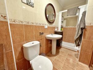a bathroom with a toilet and a sink and a mirror at Villa Ojerada - 12804 in Ajo +31 photos