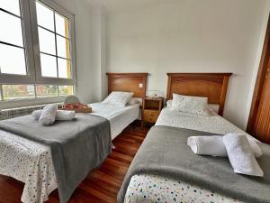 a bedroom with two beds and two windows at Villa Ojerada - 12804 in Ajo