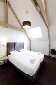 מיטה או מיטות בחדר ב-College Hotel Alkmaar