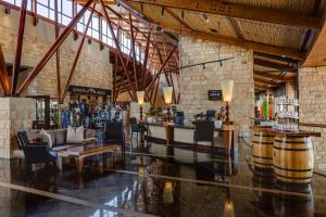 a large room with a bar and tables and chairs at Arabella Hotel, Golf and Spa in Kleinmond