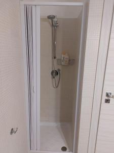 eine Dusche mit Glastür im Bad in der Unterkunft Casa Andolina White in Noto