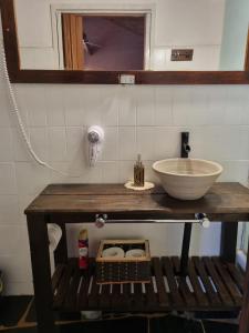 a bathroom with a counter with a sink and a mirror at Nagual B&B - Airport Shuttle in Tristán Suárez +32 photos