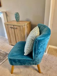 a blue chair with a pillow on top of it at Canada House - Sleeps 6 -3 King or 6 Single Ideal for contractors in Warrington