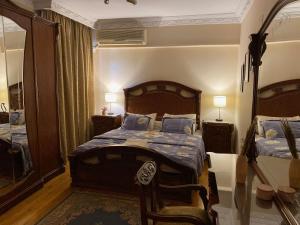 Schlafzimmer mit einem Bett und einem Spiegel in der Unterkunft Sunny 2BR Apartment in Maadi in Kairo