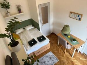a small bedroom with a bed and a table at Awesome, 15 mins to center home in Budapest