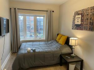a small bedroom with a bed and a window at 3-Bedroom House in Little Italy Downtown-Free Parking in Toronto