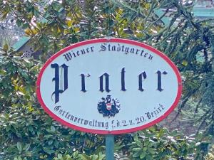 a sign for a hotel in front of a tree at Magic Vienna right next to the Prater! in Vienna