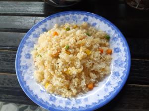 a blue and white plate of rice on a table at Hoan Chau Homestay in Phong Nha