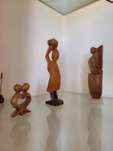 a group of wooden sculptures on display in a museum at CASA DE TECHO AZUL in Resistencia