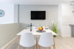 a white dining room with a white table and white chairs at La Perla del Sur - The Pearl House in Chayofa