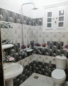 a bathroom with a toilet and a sink at Addas Home in Siwa +20 photos