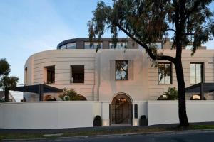 a white building with a tree in front of it at The California Romantic - Residence 3 in Melbourne