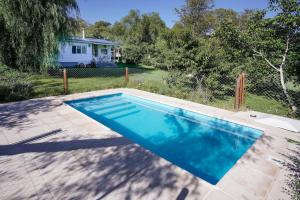 a swimming pool in front of a house at Chalet Las Doritas in La Cumbre