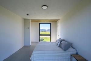 a bedroom with a large bed with a large window at Casa Puerto del Aguila - Potrero de Garay in Potrero de Garay +29 photos