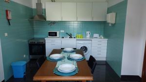 a kitchen with a table with plates on it at Retiro das Camélias in Lajes das Flores