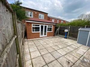 a backyard with a fence and a house at Three bedrooms house in Windsor in Windsor