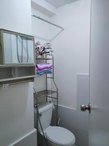 a bathroom with a toilet and a towel rack at Studio type Good for 2 Near Megamall in Manila