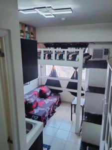 a dorm room with a bunk bed and a sink at Studio type Good for 2 Near Megamall in Manila