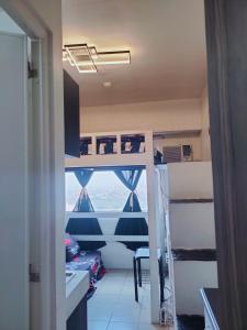 a room with bunk beds and a view of the ocean at Studio type Good for 2 Near Megamall in Manila