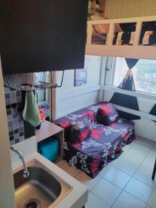 a small room with a couch next to a sink at Studio type Good for 2 Near Megamall in Manila