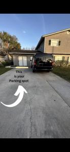 a parking spot with a car parked in a driveway at Lopez Place in Tampa