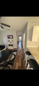 a living room with a counter and a kitchen with stools at Lopez Place in Tampa
