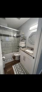 a bathroom with a toilet and a sink at Lopez Place in Tampa