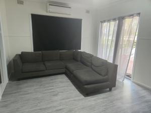 a living room with a couch and a flat screen tv at Glenwood Tourist Park & Motel in Grafton