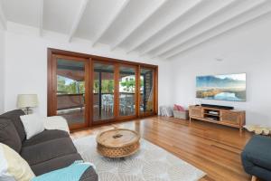 a living room with a couch and a coffee table at Castaway in Tugun in Gold Coast