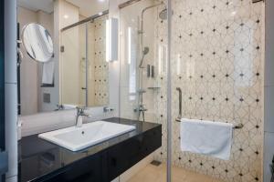 a bathroom with a sink and a mirror at Orion City Hotel in Colombo