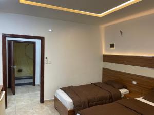 Postel nebo postele na pokoji v ubytování Al Deyafa Hotel