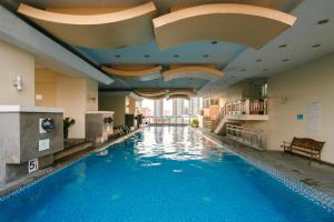 a swimming pool in a hotel with blue water at Regency Grand Suites in Manila