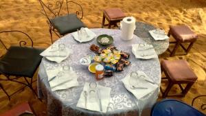 a table with plates of food on top of it at Obira Oasis Merzouga Camp in Merzouga