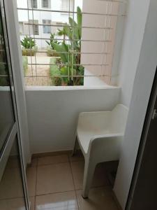 a white bench in a room with a window at joli appartement près de la mer in Casablanca