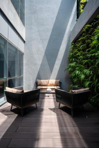 two benches sitting on a patio in a building at Orion City Hotel in Colombo