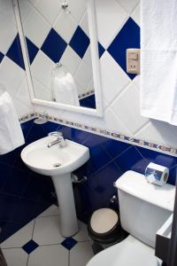 baño azul y blanco con lavabo y aseo en Hotel Diamante Azul, en La Paz