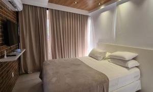 מיטה או מיטות בחדר ב-Reserva Madero Requinte Apto 104
