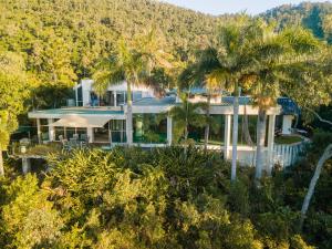 an aerial view of a house with palm trees at Yachtsmans Paradise, Whitsundays in Airlie Beach