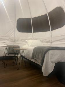 a bedroom with a bed and a table in a tent at UMA Experience in Coroico