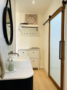 a bathroom with a white sink and a mirror at Glenbosch Wine Estate Farm Stays in Beechworth
