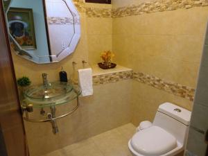 a bathroom with a sink and a toilet at MView: Comfortable, great location, city view in Santiago de los Caballeros
