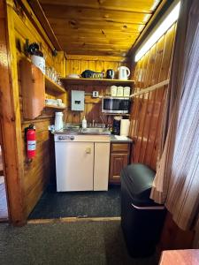 a small kitchen with a sink and a stove at Sun Valley Cottages in Weirs Beach