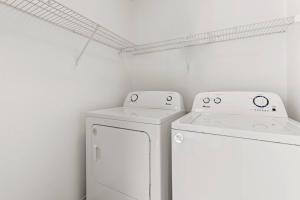 a laundry room with a washer and dryer at Unit 213 - The Strand 2 Bed - Cation on the Guadalupe in New Braunfels