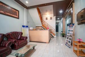 a lobby of a pharmacy with couches and a counter at RedDoorz Syariah near Danau Lut Tawar Takengon in Takengon