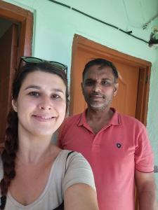 a man and a woman standing in front of a door at Narmada Guest House in Indore